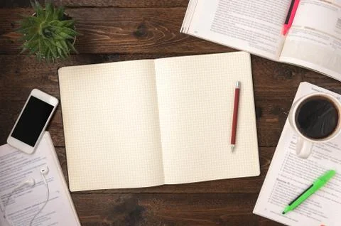 Top view of an open books with cup of coffe, smartphone, home plant and open  Stock Photos