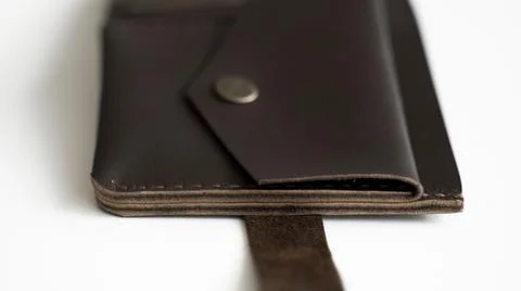 Top view of open brown empty man's black handmade genuine leather wallet with Stock Photos