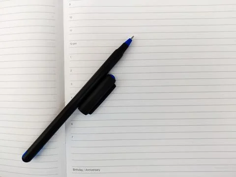Top view of open diary with pen and cap. Copy space Stock Photos