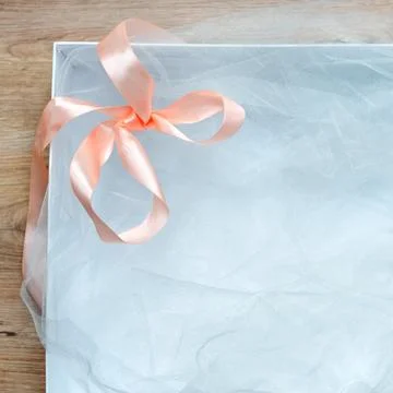 Top view of open empty gift box on wooden table. White gift box with ribbon b Stock Photos