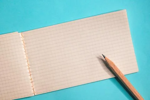 Top view of open graph paper notebook and pencil, simple stationery composi.. Stock Photos