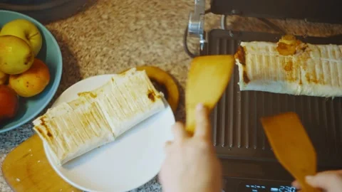 Top view of an open grill, removing the finished shawarma with wooden spatulas Stock Footage 237445350
