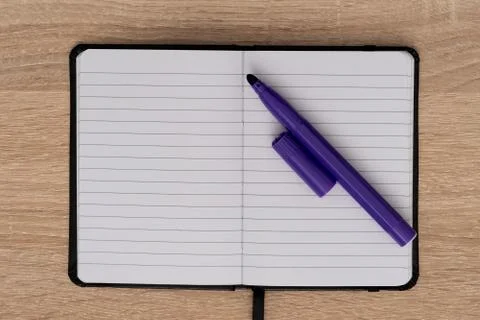 Top view of open notebook and blue marker Stock Photos