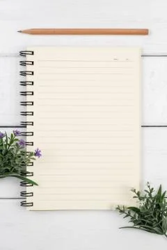 Top view of an open notebook with pencil on white wooden desk Stock Photos