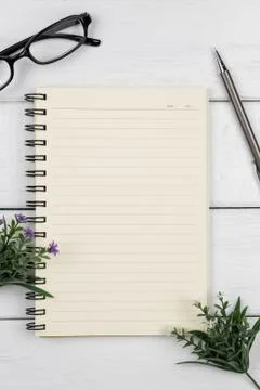 Top view of an open notebook with pencil on white wooden desk Stock Photos