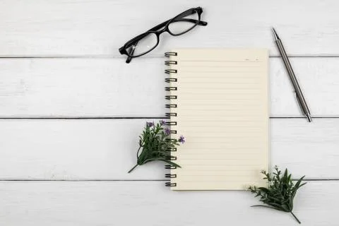 Top view of an open notebook with pencil on white wooden desk Stock Photos