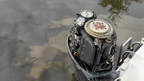 Top view of an open outboard boat motor mounted on a watercraft floating on Stock Photos