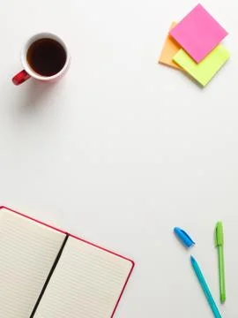 Top view of an open red notebook, colored reminders, blue and green pen, a re 写真素材