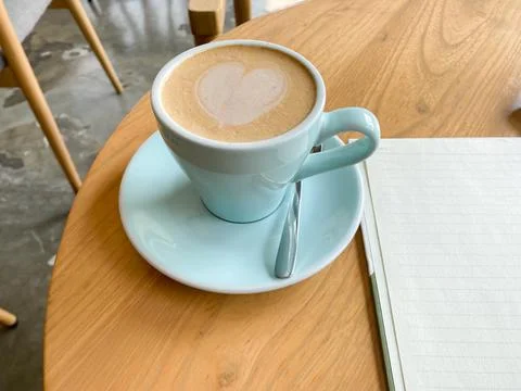 Top view of open school notebook with blank pages, coffee cup and pencil for  Stock Photos