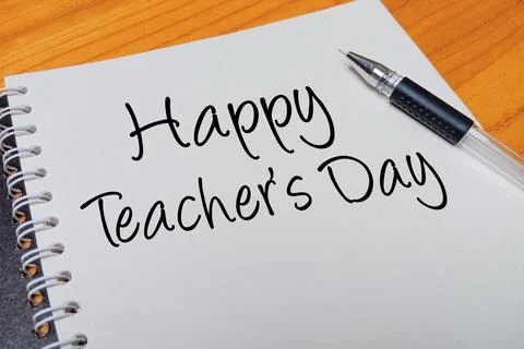 Top view of an open spiral notebook with Happy Teacher's Day handwritten te.. Stock Photos