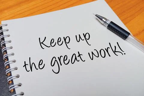 Top view of an open spiral notebook with Keep up the great work! handwritte.. Stock Photos