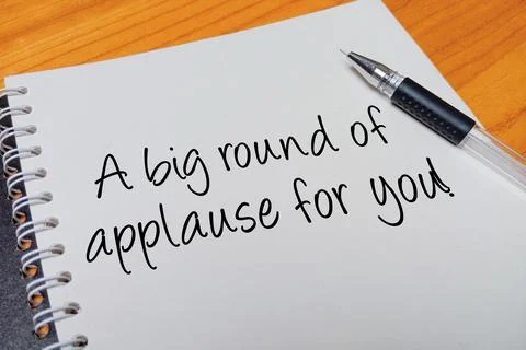 Top view of an open spiral notebook with A big round of applause for you! h.. Stock Photos