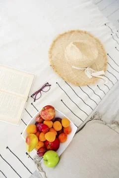 Top view of opened book with glasses and plate of delicious colorful fruit with Stock Photos
