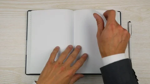 Top view of opened diary, businessman flipping the page Video stock 96988880