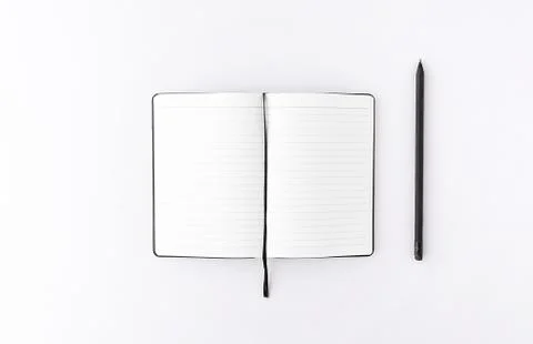 Top view of opened notepad with black pencil white background. Mockup for your Stock Photos