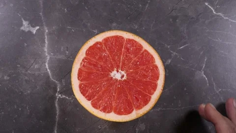 Top view of Opening a Grapefruit Stock Footage 242381827