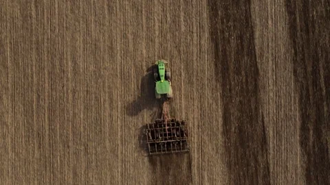 Top view or aerial drone view on tractor plows the agricultural field Stock Footage 271656880