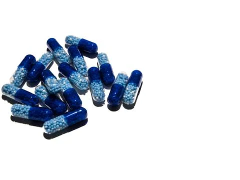 Top view or concept of blue, semi transparent pills on white background. Stock Photos