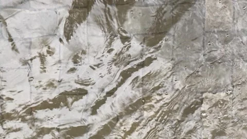 Top view or flat lay view of shallow water flow on grey paved background Stock Footage 293783934