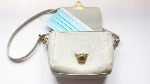 Top view or flat lay of woman's bag accessories with hygienic mask and sanitizer Stock Photos