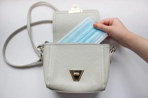 Top view or flat lay of woman's bag accessories with hygienic mask and sanitizer Stock Photos