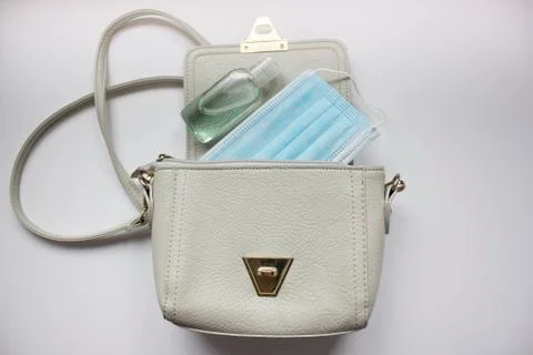 Top view or flat lay of woman's bag accessories with hygienic mask and sanitizer Stock Photos
