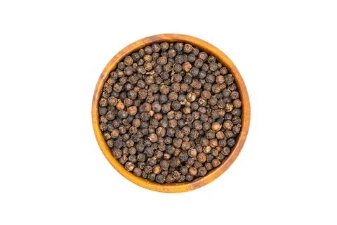 Top view or flat lay of fresh raw blackpepper in wooden bowl. Stock Photos