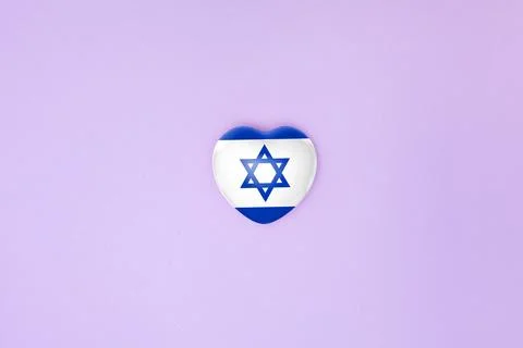 Top view or flat lay of heart with print of Israel flag on purple backgroun.. Stock Photos