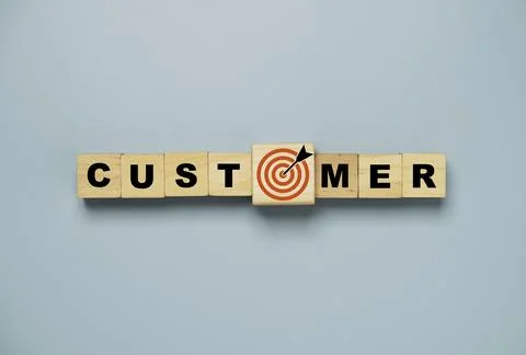 Top view or flat lay of customer wording on wooden cube block with red targ.. Stock Photos