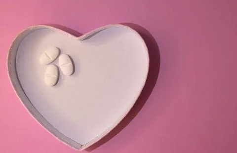 Top view or heart-shaped figure with white pills on one side Sapace for text. Stock Photos