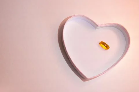 Top view or heart-shaped figure with transparent capsule. Sapace for text. Stock Photos