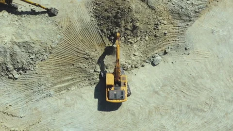 Top view of orange excavator working in quarries site Stock Footage 202617560