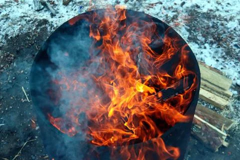 Top view of an orange flame in an old iron barrel Stock Photos