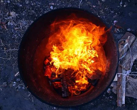 Top view of an orange flame in an old iron barrel Stock Photos