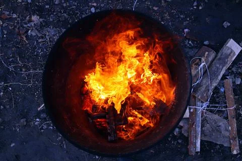 Top view of an orange flame in an old iron barrel Stock Photos