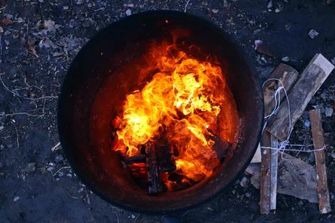 Top view of an orange flame in an old iron barrel Stock Photos