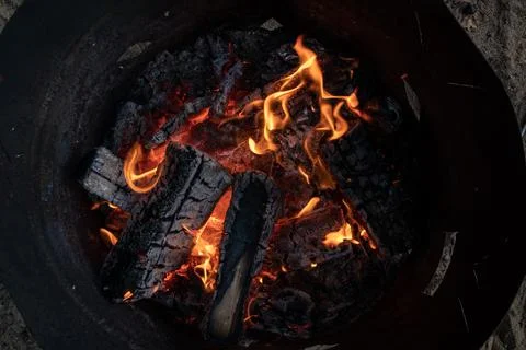 Top view of an orange flame in an old iron barrel Stock Photos
