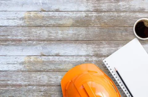 Top view with orange safety engineer helmet and blank notebook or notepad and Foto stock