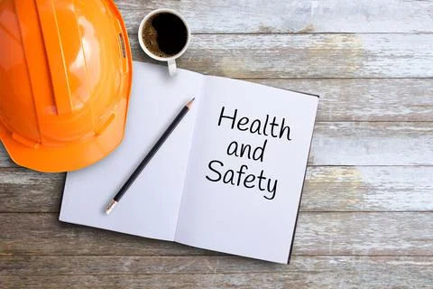 Top view with orange safety engineer helmet,cup of coffee on wood table Stock-Fotos