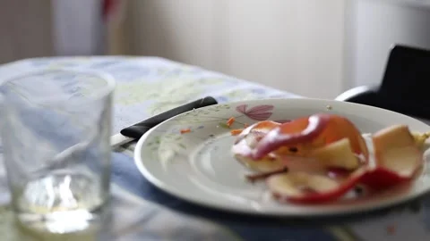 Top view of organic red apple peels left on a ceramic plate Stock Footage 345737028