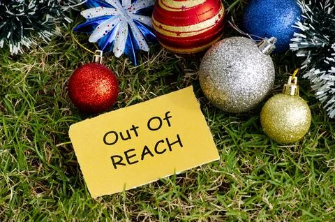 Top view of Out of REACH text with Christmas decoration background. Photos