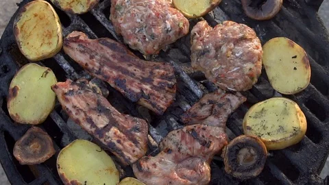 Top view over barbecue with ribs, meatballs and potatoes Stock-Footage 87999839