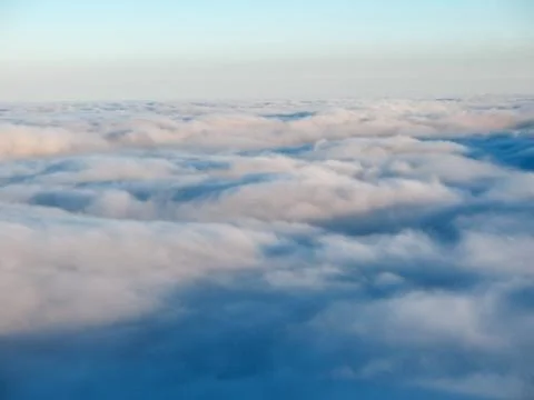 Top view over cloud cover in the mountains. Waves from the clouds. Stock Photos