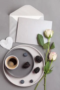 Top view over coffee cup, and gray postcard with envelope Stock Photos