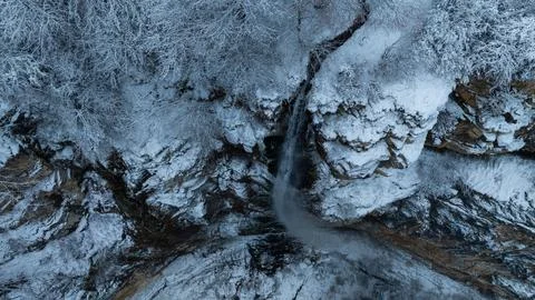 Top view over rocks and waterfall in snow Stock Photos