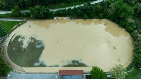 Top view over a small stadium flooded with muddy water after a disaster Stock Photos