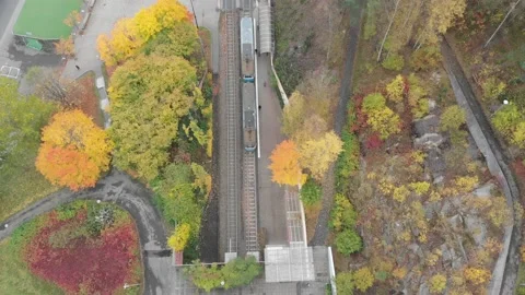 Top view over Tram Train Stop and Commuter Walking, Autumn, Aerial Stock Footage 143725855