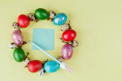 Top view painted eggs Easter Frame in circle shape on a yellow background. Co Stock Photos
