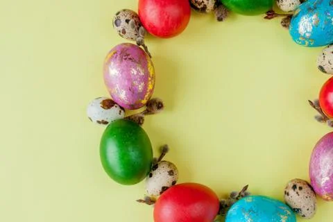 Top view painted eggs Easter Frame in circle shape on a yellow background. Co Stock Photos