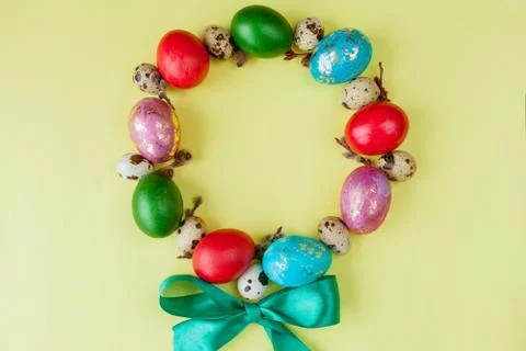 Top view painted eggs Easter Frame in circle shape on a yellow background. Co Stock Photos